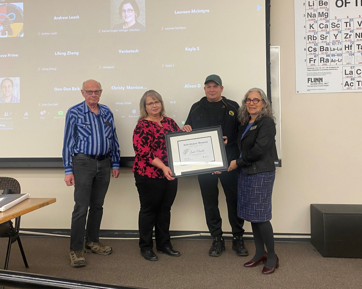 Linda Nemeth accepting the Clement Memorial Service Award presented by Kelly Clement's family and CGPS Dean Debby Burshtyn