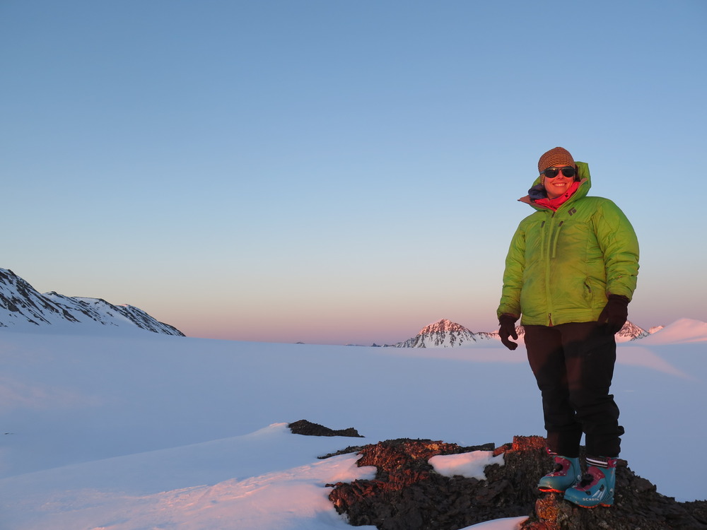 Caroline Aubry-Wake, PhD, standing on top of a mountain while conducting research
